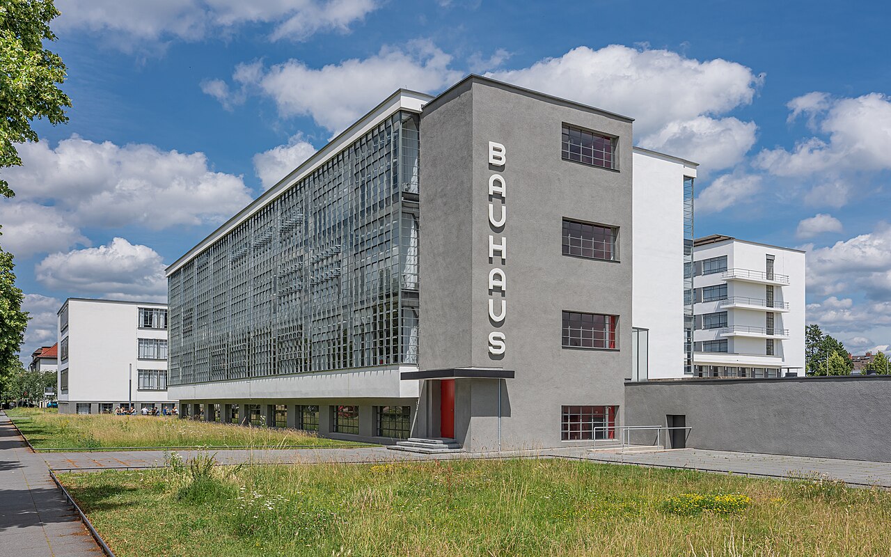 The Bauhaus campus in Dessau, designed by Walter Gropius. The glass curtain wall and structural grid became the ultimate architectural manifestation of the school’s objective, functional philosophy.
